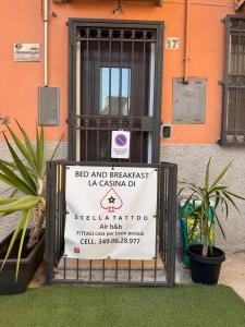 a sign on a gate in front of a building at La casina di Stellatattoo in Crotone