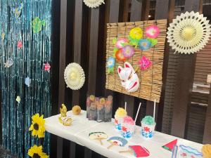 a table with a white table with balloons and decorations at APA Hotel Nagoya Sakae Ekimae EXCELLENT in Nagoya