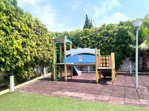 a playground in a park with a gazebo at NissiLant hotel & suites in Ayia Napa