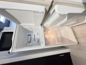 an empty refrigerator door is open in a kitchen at NDZ103 3 min walk to station, 2 lines, Yamanote Line, high-speed Wi-Fi in Tokyo