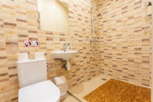 a bathroom with a toilet and a sink at Poilsio sodyba "Spalio krantas" in Giedraičiai +21 photos