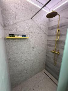 a bathroom with a shower with a stone wall at Barocco Island Studios in Skala Potamias +12 photos