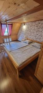Postel nebo postele na pokoji v ubytování Apartamenty i Domki Biały Dunajec