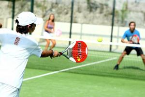 Un uomo che dondola una racchetta da tennis a una palla da tennis di Casa Lily on Vistabella Golf a Vistabella
