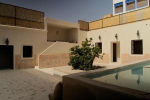 a house with a swimming pool next to a building at Riad Ait Sonia in Tamraght Ouzdar