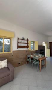 a living room with a table and a couch at Casa di Vita in Marina di Lizzano +56 photos