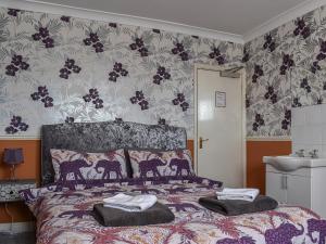 a bedroom with a bed with two pillows on it at Vincent House in Scarborough
