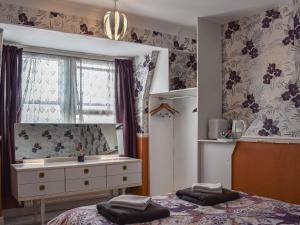 a bedroom with a bed and a dresser and a window at Vincent House in Scarborough +24 photos