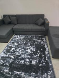a living room with a couch and a rug at 3BR furnished apartment in Madinaty B1 شقة مفروشة 3 غرف نوم في مدينتي in Madinaty
