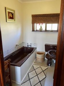 a bathroom with a large tub and a sink at Sedgefield Vacation Home in Sedgefield +30 photos