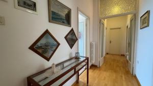 a living room with a table and paintings on the wall at casAmare in Pescara