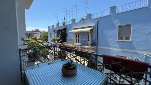 a balcony with a blue table and a building at casAmare in Pescara