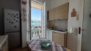 a small kitchen with a table with a bowl on it at casAmare in Pescara