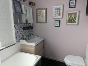 a bathroom with a white sink and a toilet at La Maison des Docks - 30min de Tours in Villaines-les-Rochers