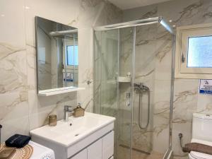 a bathroom with a sink and a shower at Magda's Cosy House Fourka in Fourka +39 photos