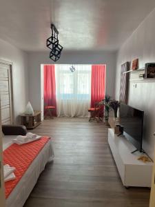 a bedroom with a bed and a large window at Dima Residence in Mangalia