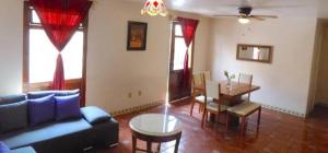 a living room with a couch and a table at H san Carlo suite in Guanajuato