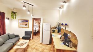 a living room with a couch and a table at North valley winery suite in Bet Hillel