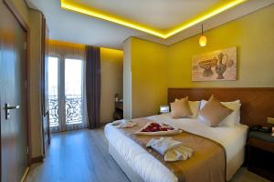 a hotel room with a bed with a plate of food on it at Corner Hotel Laleli in Istanbul +25 photos