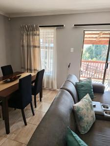 a living room with a couch and a table at Cleo's Corner in East London