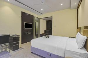 a bedroom with a large bed and a flat screen tv at Hotel Namaste Inn in Hyderabad +3 photos