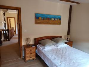 a bedroom with a bed and a picture on the wall at Gite medieval St Jacques in Parthenay +3 photos