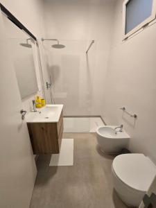 a bathroom with a toilet and a sink and a shower at B&B Casa Cappuccini in Tricase
