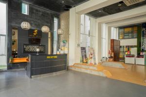 a restaurant with a counter in a large room at DREAM INN Aeropolis By Reccoma in Teko