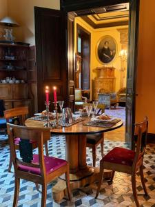 a dining room with a table with candles on it at Villa Angela Neuer Rosengarten in Velbert