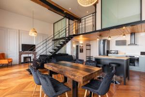 a dining room with a wooden table and chairs at Smartstay - Vue panoramique sur Lyon et la saone in Fourvière