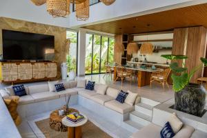 a living room with a couch and a table at Paje Emerald Escapes in Paje