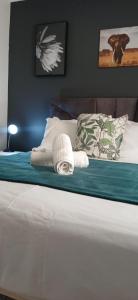 a bed with a blanket and a pillow on it at Cleo's Corner in East London