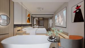 a hotel room with a bed and a white tub at Bi'an Time Hotel -Chongqing Guanyin Bridge Branch in Chongqing