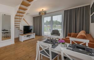 a living room with a couch and a table at Słoneczna Zatoka in Władysławowo