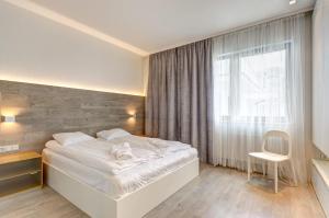 Ένα ή περισσότερα κρεβάτια σε δωμάτιο στο Dom & House Szafarnia Modern Apartments on the Motława River Gdańsk