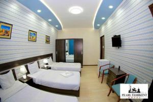 Ένα ή περισσότερα κρεβάτια σε δωμάτιο στο Pearl Tashkent +17 φωτογραφίες