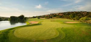 an aerial view of a golf course with a lake at Big 5 Cottage in Pretoria