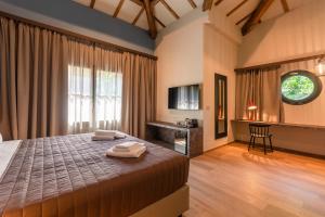 a bedroom with a bed with two towels on it at CasaCabe - Boutique Living in Imola
