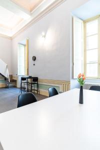 ローマにあるAltana del Borgo - Luxury Flatの椅子と花瓶付きのテーブルが備わる部屋