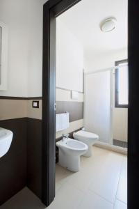 a bathroom with two toilets and a sink at Hotel San Martino in Cassibile +42 photos