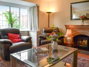 a living room with two chairs and a fireplace at Number Three in Bridlington