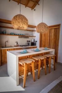 a kitchen with a table and some chairs and some lights at Paje Emerald Escapes in Paje
