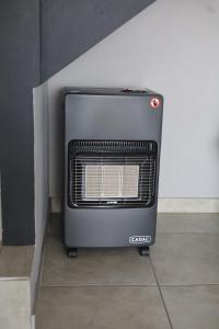a heater sitting on the floor next to a wall at Forest-Riversend in Pietermaritzburg