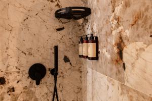 a bathroom with two lights on a stone wall at Flora Guest House in Rome