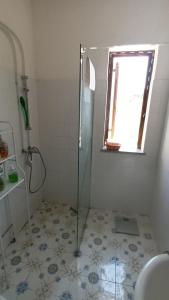 a bathroom with a shower with a glass door at Casasvedese agriturismo in Marina