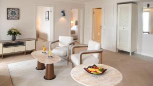 a living room with a bowl of fruit on a table at Amadria Park Grand Hotel 4 Opatijska Cvijeta in Opatija
