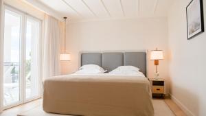 a bedroom with a large bed and a large window at Amadria Park Grand Hotel 4 Opatijska Cvijeta in Opatija