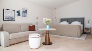 a living room with a couch and a table and a bed at Amadria Park Grand Hotel 4 Opatijska Cvijeta in Opatija