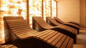 three wooden benches sitting next to a window at Amadria Park Grand Hotel 4 Opatijska Cvijeta in Opatija