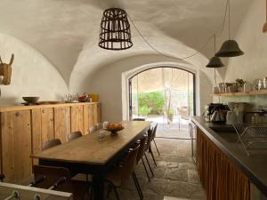 a kitchen with a table and chairs in a room at Château d'Uzer in Uzer